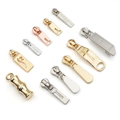 China Custom Logo Metal Zipper Pull Design Handbag Metal Zipper Puller Nickel Free Slider For Jacket for sale