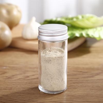 China Sustainable 100ml Round Spice Bottles Glass Spice Jars With Silver Metal Lids Airtight Clear Chart Label Pour / Sieve Shakers for sale