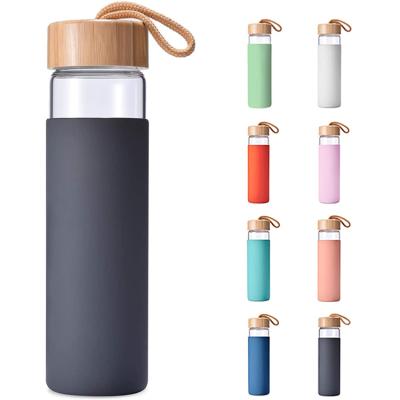 China 20oz Sustainable Free Drinking Large Reusable Portable High Borosilicate Glass Water Bottles With Bamboo Lid And Silicone Sleeve for sale