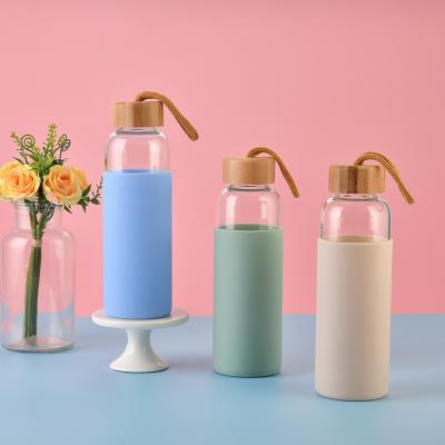 China Sustainable Portable Glass Water Bottle With Borosilicate Glass Lid Protective Silicone And Bamboo Sleeve Water Bottle for sale