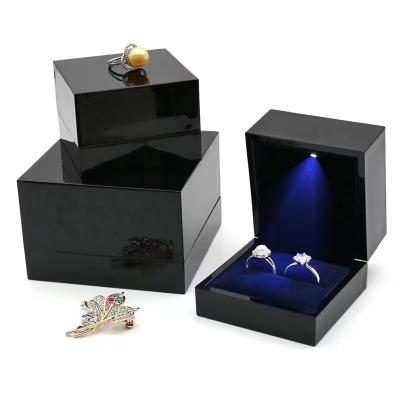 China Fashion Luxury Black Plastic Jewelry Case Lacquered Wedding Ring Pendant Jewelery Packaging With Led Light Box for sale