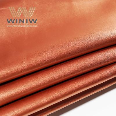 Cina 1.4mm Orange Micro Fiber PU Vegan Leather Bags Making Leather Fabric Material in vendita