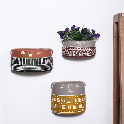 China Novelty Design Popular Modern Indoor Outdoor Decorative Cute Cement Planters Wall Mounted Hanging Pots For Home Decor for sale