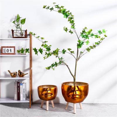 China Hot Selling Novelty Big Floor Stand Hotel Indoor Face Decoration Gold Bulk Custom Made Bulk Fiberglass Pots For Plants Flower for sale