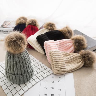 China JOINT Custom Thick Ball Pom Pom Beanie Hat Faux Raccoon Fur Logo Women Winter Hat Knitted Hat Removable Pom for sale