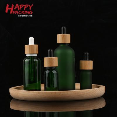 China Beard Oil Cosmetic Glass Bottles 30ml 50ml 100ml Beard Oil Boston Green Round Glass Bottle With Dropper for sale