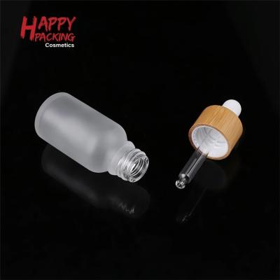 China 60 120 ml cosmetic 2 4 oz clear frosted bamboo glass essential oil dropper bottle for sale