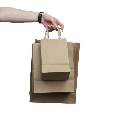 China Custom Logo Shopping Kraft Paper Bag Suppliers China Recyclable Paper Bag Packaging Shop Bags With Handle for sale