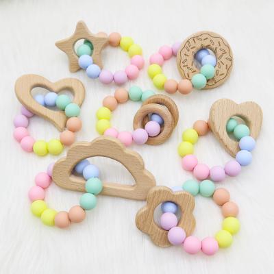 China DIY Non-Toxic Beech Wood Baby Teething Ring Silicone Bracelet Rattle Toys for sale