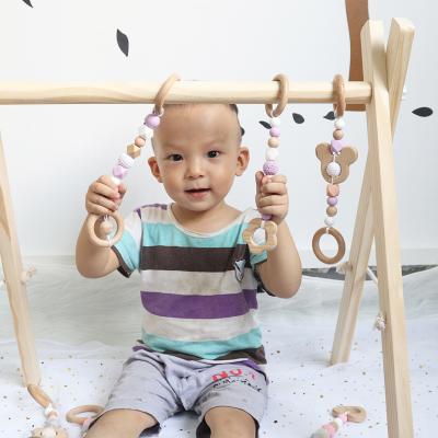 China Eco-Friendly Organic Natural Handing Sensory Toy Wooden Activity Play Gym For Babies for sale