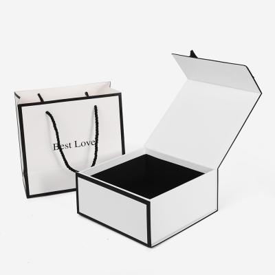 China Handmade Luxury Custom Black White Paper Bag Cardboard Gift Magnetic Paper Storage Box With Ribbon for sale