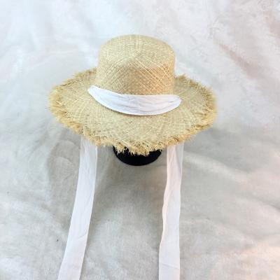 China Straw Hats Women White Flat Cap Temperament Bow Image Beach Raffia Hat Black Ribbon Seaside Hat for sale