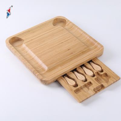 China Sustainable Family Camping Party Natural Bamboo Groove Width Wooden Board With Cheese Knife And Fork Set for sale