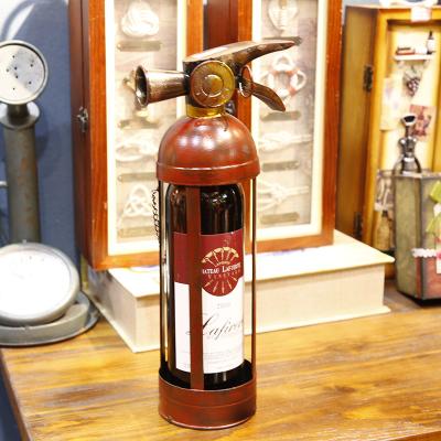 China Viable Newcomer Courage Metal Fire Extinguisher Shaped Single Bottle Red Wine Rack Wine Rack For Home Decoration for sale