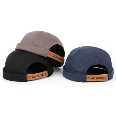 China COMMON Hot Selling White Visorless Leather Strap Buckle Hat Canvas 6 Panel Round Brimless Hat for sale