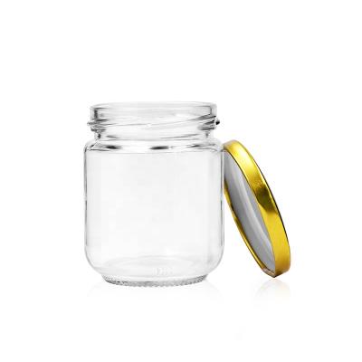 China Hot Selling 200ml Wholesale Empty Clear Food Jars Sweet Food Glass Honey Storage With Tinplate for sale