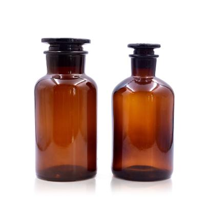 China 60ml/125ml/250ml/500ml/1000ml medicine factory stock round shape custom amber empty glass medicine bottle with glass cork for sale