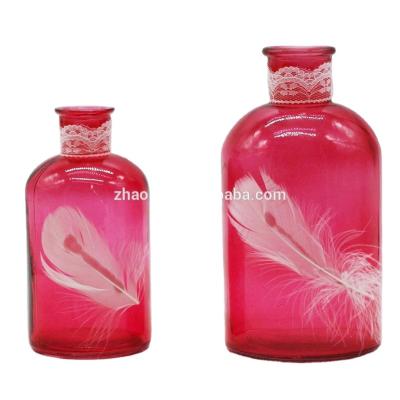 China Modern Art Unique Red Glass Bottle with Feather for sale