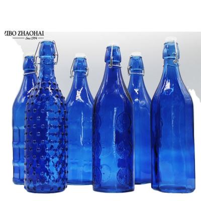 China Wholesale Cheap Empty Blue Colored Cylindrical Beverage Beer Wine Glass Bottle With Swing Top Cap for sale