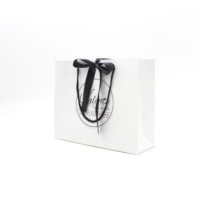 China Custom Logo White Shopping Paper Bag Recyclable With Black Ribbon Closure Gift Bags for sale