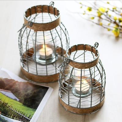 China Retro Home Decoration Candle Holder Metal Glass Opens Wrought Iron Hemp Rope Lantern Portable Wooden Candle Holder for sale