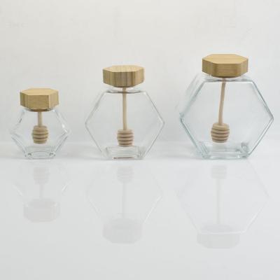 China Home New Design Hexagonal Glass Honey Jars With Wooden Lids And Plunger 100ml 180ml 280ml 380ml for sale