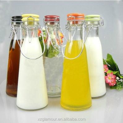 China Vintage Style 500ml 1000ml Round Flip Top Vintage Style Glass Milk Bottles With Swing Top for sale