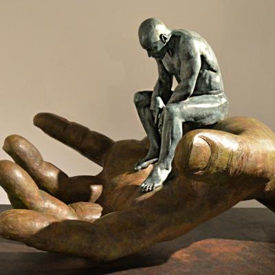 China China modern famous illustration abstract bronze nude man sitting on a big hand statue for sale