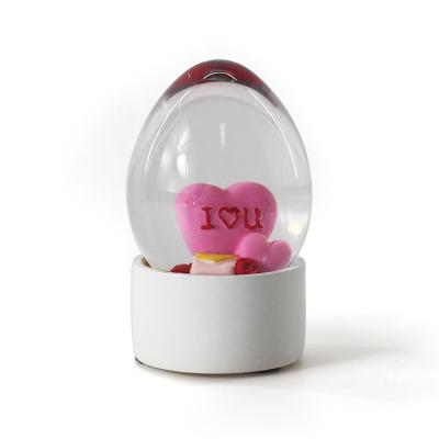 China China Custom Design Decoration Heart Shape White Egg Plastic Snow Globe for sale