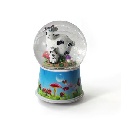 China China Custom Music Turn Plastic Cow Snow Globe for sale