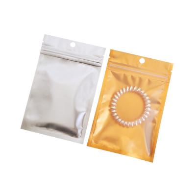 China Moisture Proof In Front Transparent Mylar Stock Holographic Ziplock Packaging Small Zipper Lock Bags for sale