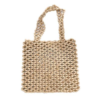 China 2021 new high quality retro wooden beads hand - woven hollow bag beaded handbag straw bag women handbag for sale