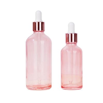 China High Quality Cosmetic Packaging 30ml Transparent Cosmetic Peach Essential Oil Bottles 10ml Glass Base Pink Liquid Bottle for sale