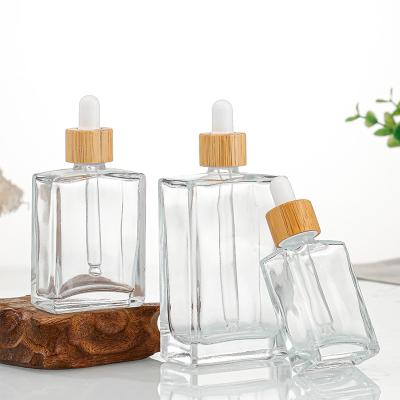 China Cosmetic Stain Can Be Essential Oil Clear Skin Care Serum Rectangle Glass Dropper Customized Wooden Bottle With Bamboo Lid for sale