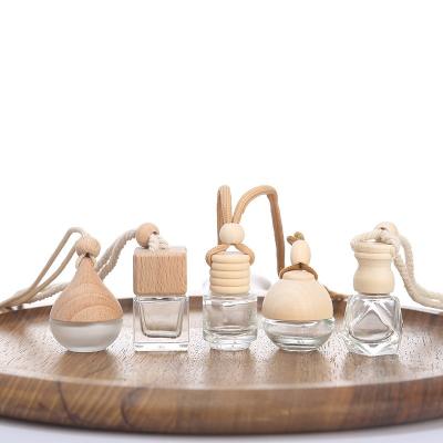 China Perfume Cosmetic Aromatherapy Pendant Bottle with Wooden Hanging Cap and String Car Diffuser Square Empty Clear Glass Air Freshener for sale