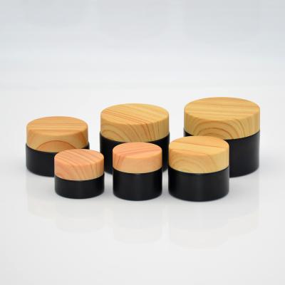 China Top quality widely used black personal care cream bottle covered with wood grain for sale