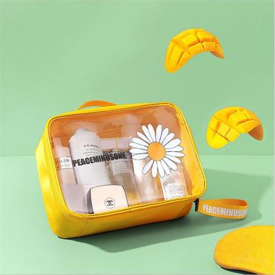 China Large Capacity PVC Daisy TPU Transparent Cosmetic Bag Lazy Portable Storage Bag for sale