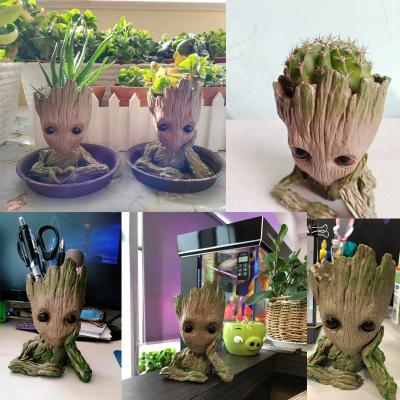 China DOULUO Polyresin Flowerpot Baby Groot Cute Popular Eco-friendly Pen Pot Treeman Model Hands Figure on Chin Cute Green Plants Flowerpot for sale