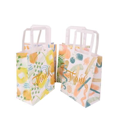 China Cheap Disposable Flower Pattern Paper Gift Bag Handle Paper Gift Packaging Bag Organizer With Custom Logo for sale