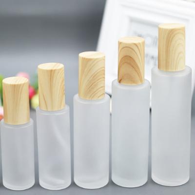 China High Quality Frosted Exquisite High Qiality Cover Sample Reagent Glass Lotion Bottle Bamboo Wood Spray Cover Press Bottle Glass for sale