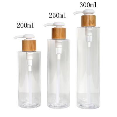 China Sustainable Leakproof 300ml Shampoo Bamboo Pump Plastic Cylinder Bottles With Wrap Around Dish Soap Dispenser for sale