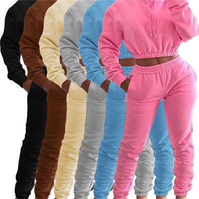 China Anti-pilling fashion ladies fall long sleeve solid color pocket plush hoodie crop top jogging pants women two piece set for sale