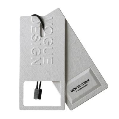 China Sustainable luxury custom hang tags with logo Design and printing fashion garment tag embossed clothing swing tag with string for sale