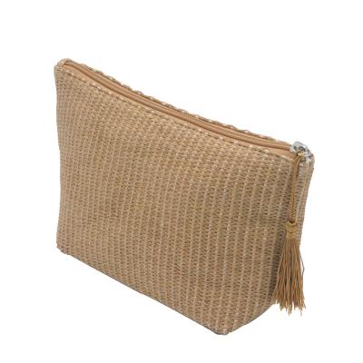 China Normcore/Main Makeup Pouch Straw Bag Cosmetic Bag Trapezoid Shape Zipper Closure Minimalist Viable Natural Tassel Zipper for sale