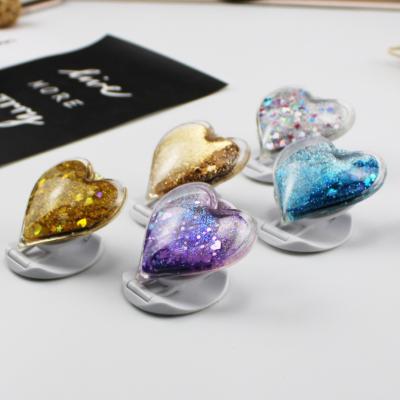 China Universal Adjustable Heart Glitter Love Quicksand Phone Holder Ring Stand Gift Finger Phone Hold Liquid Phone for sale