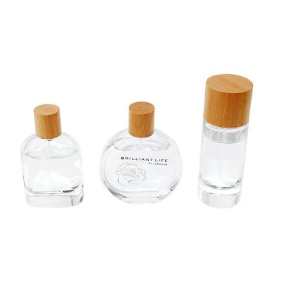 China Non Spill TAOTAOJU Cosmetic Packaging Custom Aromatherapy Wooden Cover High Quality Beech Wood Perfume Bottle Glass Lid for sale