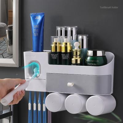 China Newer Bathroom Wall Mounted Punch Free Toothpaste Holder Plastic Toothpaste Dispenser Sustainable for sale