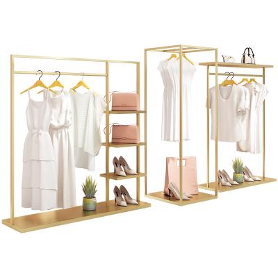 China Clothes shop boutique women's fabrics shop furniture steel gold metal clothes rack clothing rack garment rack with shelves for sale