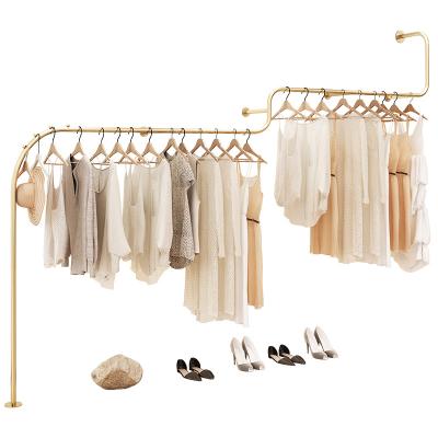 China Clothes shop new creative design shiny polished gold stainless steel women's clothing rack for sale