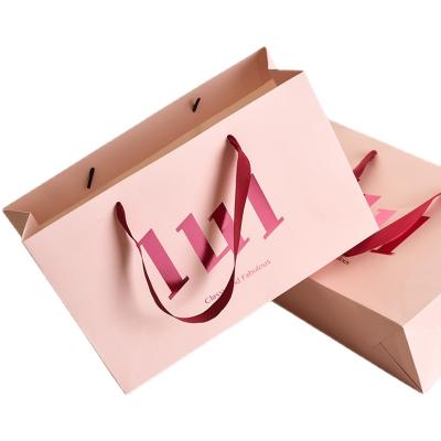 China Recyclable custom luxury clothing retail bag packing bolsas de papel pink shopping bag gift packaging paper bags with handles for clothes for sale